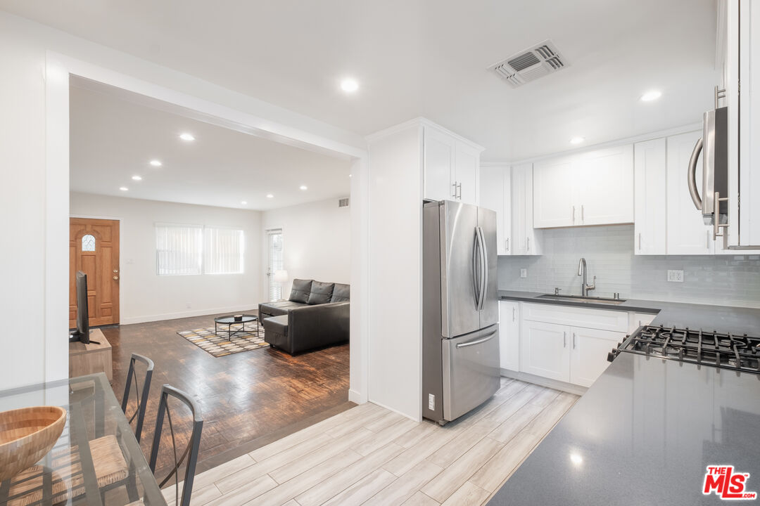 1024 Maple Street, Unit 1 Santa Monica, CA 90405 - Photo 8 of 16 a kitchen with stainless steel appliances granite countertop a refrigerator and a stove top oven