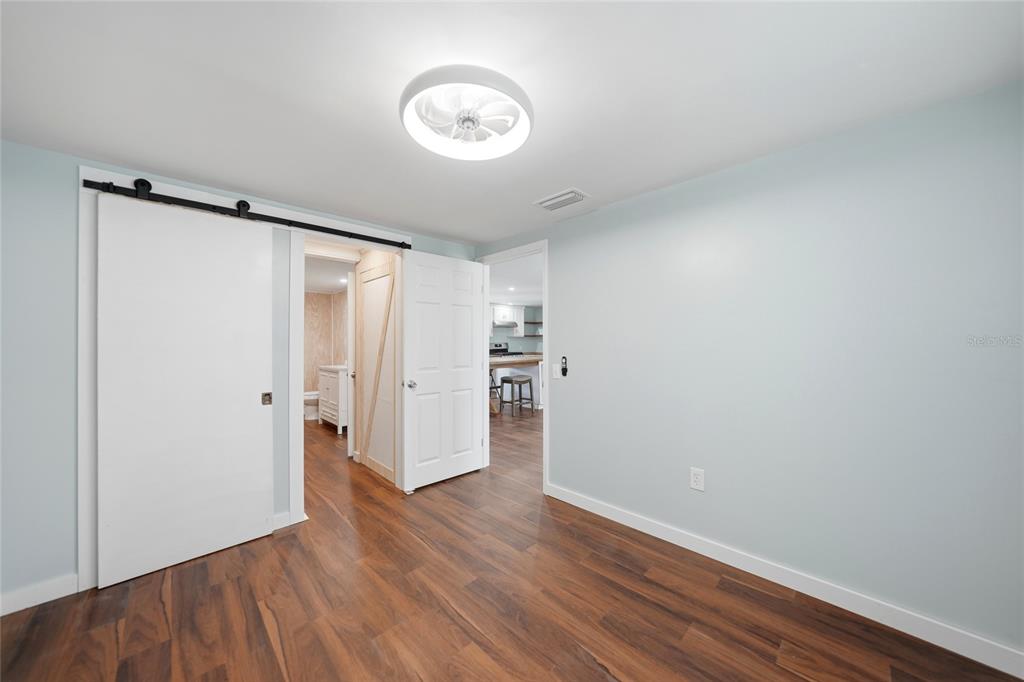 8164 Archie Street Englewood, FL 34224 - Photo 13 of 42 a view of a room with wooden floor