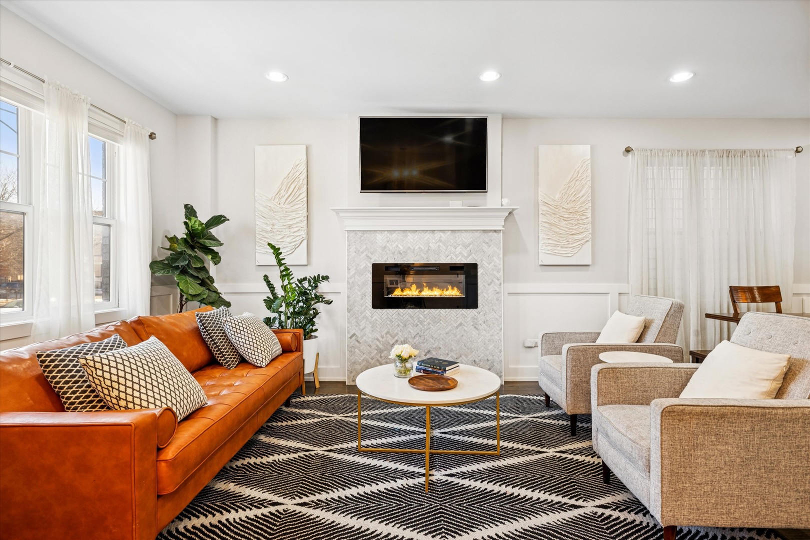 4744 South Indiana Avenue Chicago, IL 60615 - Photo 2 of 27 a living room with furniture a fireplace and a flat screen tv