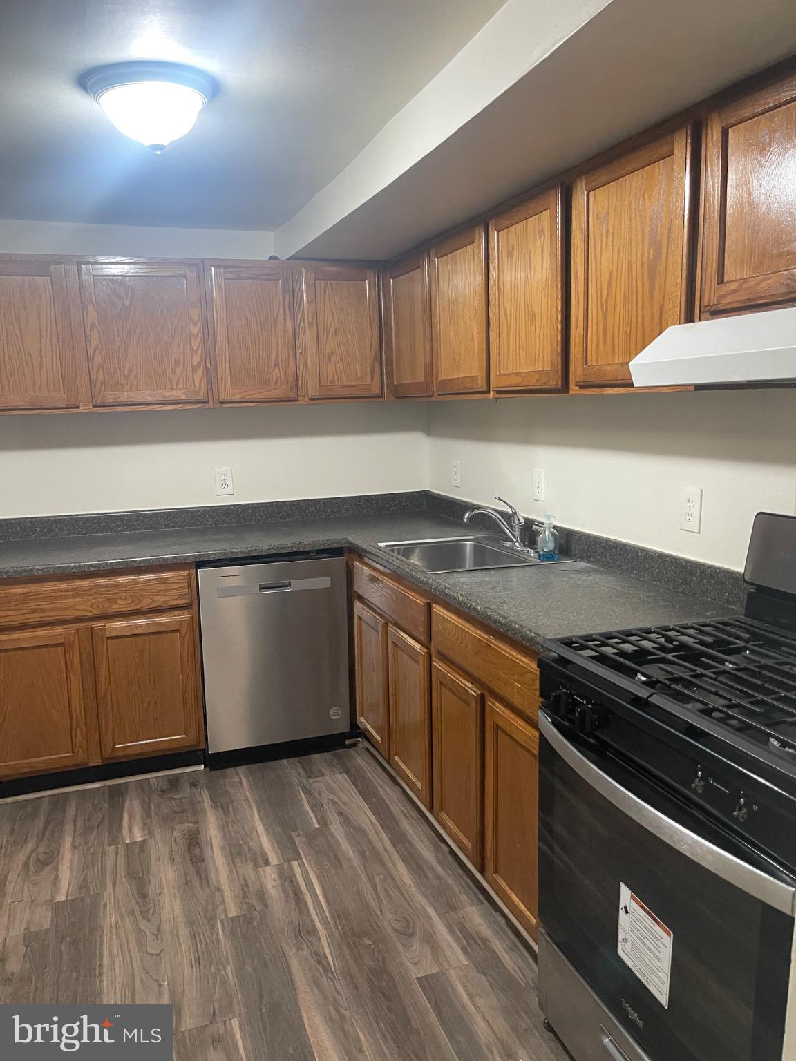 2360 Sun Valley Circle, Unit 2GH Silver Spring, MD 20906 - Photo 18 of 28 Modern kitchen with warm wood cabinetry.