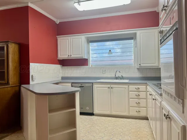 a kitchen with sink cabinets and stainless steel appliances