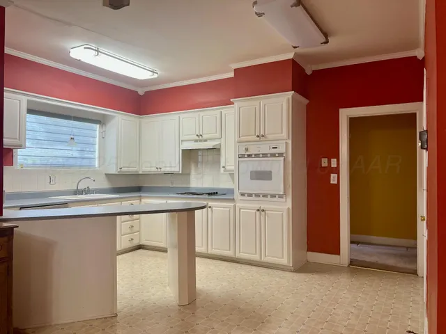 a kitchen with stainless steel appliances granite countertop a sink and dishwasher a refrigerator