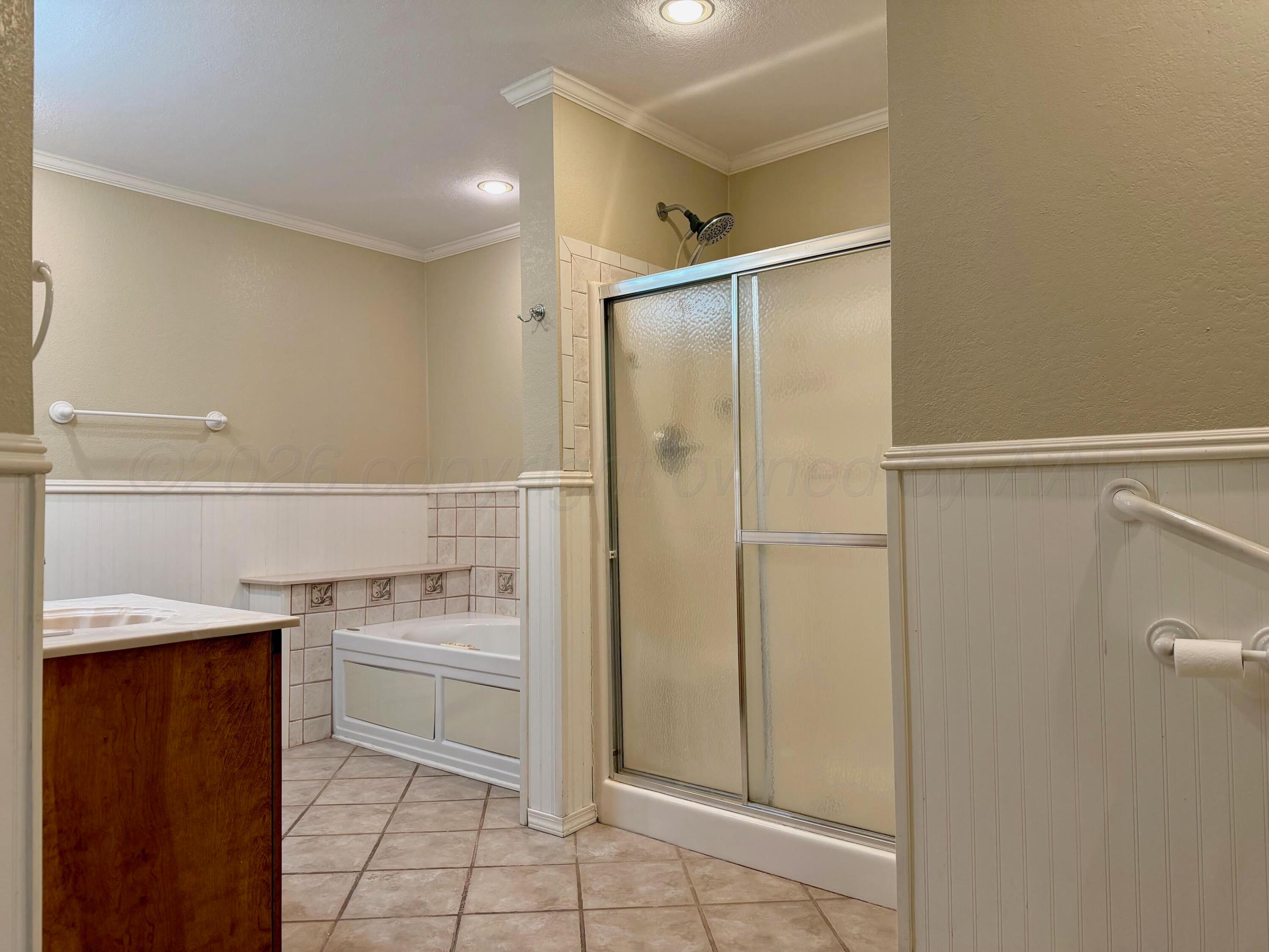 920 Montgomery Street Memphis, TX 79245 - Photo 13 of 30 a bathroom with a sink a mirror and a shower