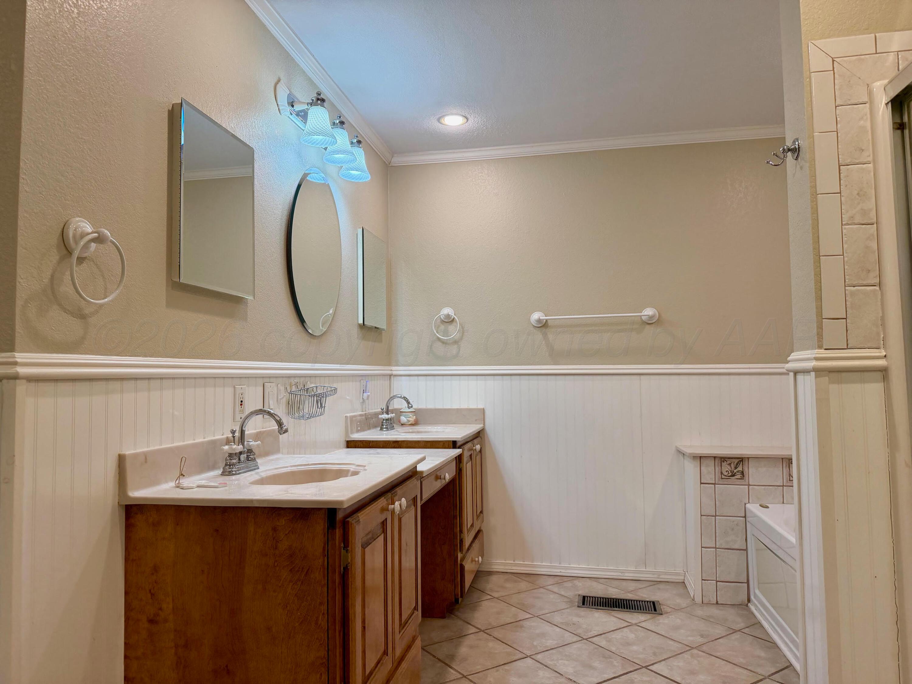 920 Montgomery Street Memphis, TX 79245 - Photo 14 of 30 a bathroom with a sink and a mirror