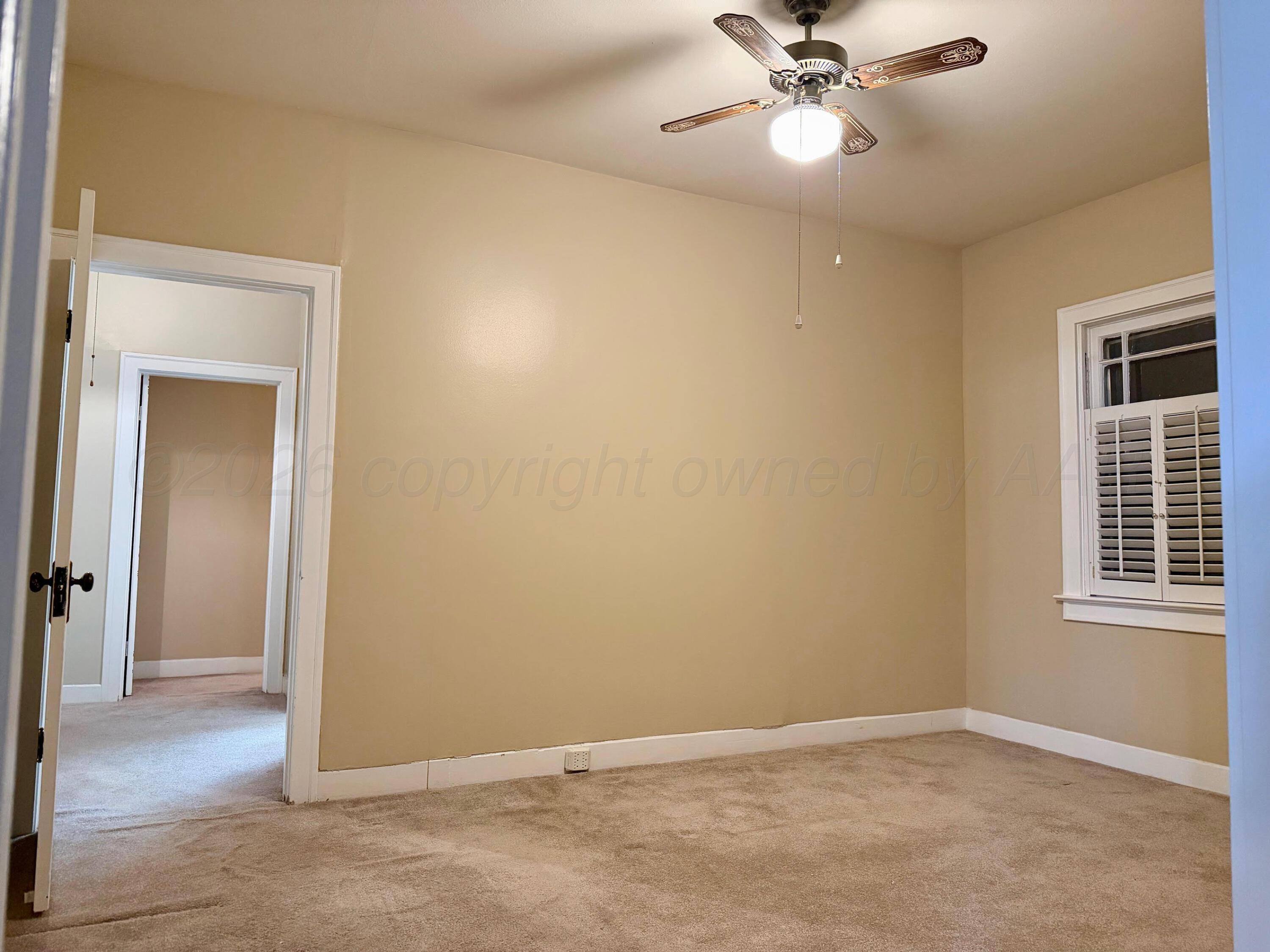 920 Montgomery Street Memphis, TX 79245 - Photo 16 of 30 a view of an empty room and a chandelier fan