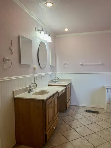 a bathroom with a double vanity sink mirror and toilet