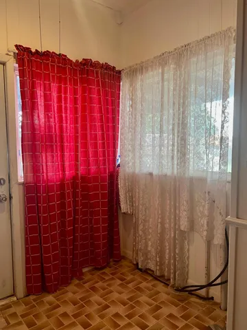 a bathroom with a shower curtain and a window