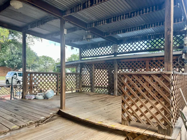 a view of a backyard with wooden fence