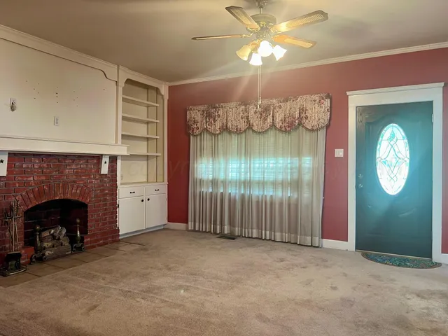a view of a livingroom with an empty space and a fireplace