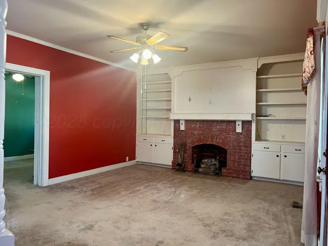 a view of an empty room with a fireplace