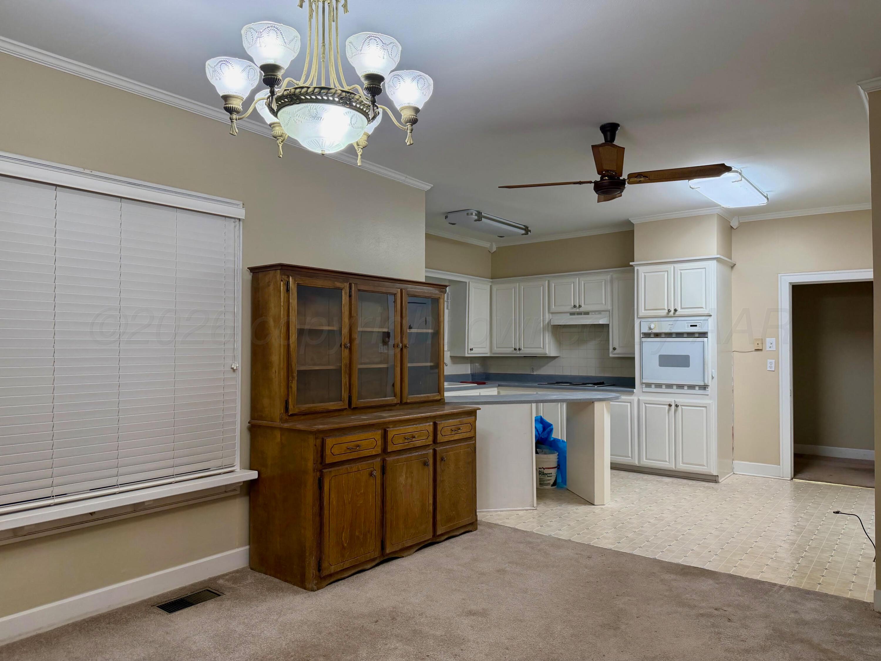 920 Montgomery Street Memphis, TX 79245 - Photo 7 of 30 a kitchen with cabinets and stainless steel appliances