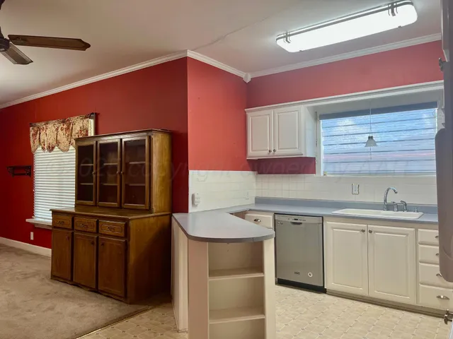 a kitchen with a sink and cabinets