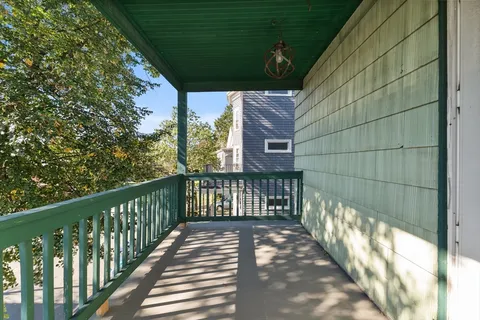 a view of a balcony with wooden floor
