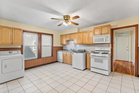 a kitchen with a stove a sink and a refrigerator