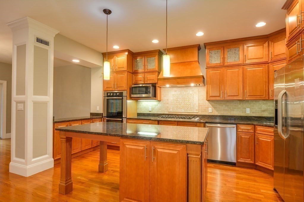 50 Tanglewood Road Newton, MA 02459 - Photo 11 of 42 a kitchen with stainless steel appliances granite countertop a sink a stove and a wooden floors