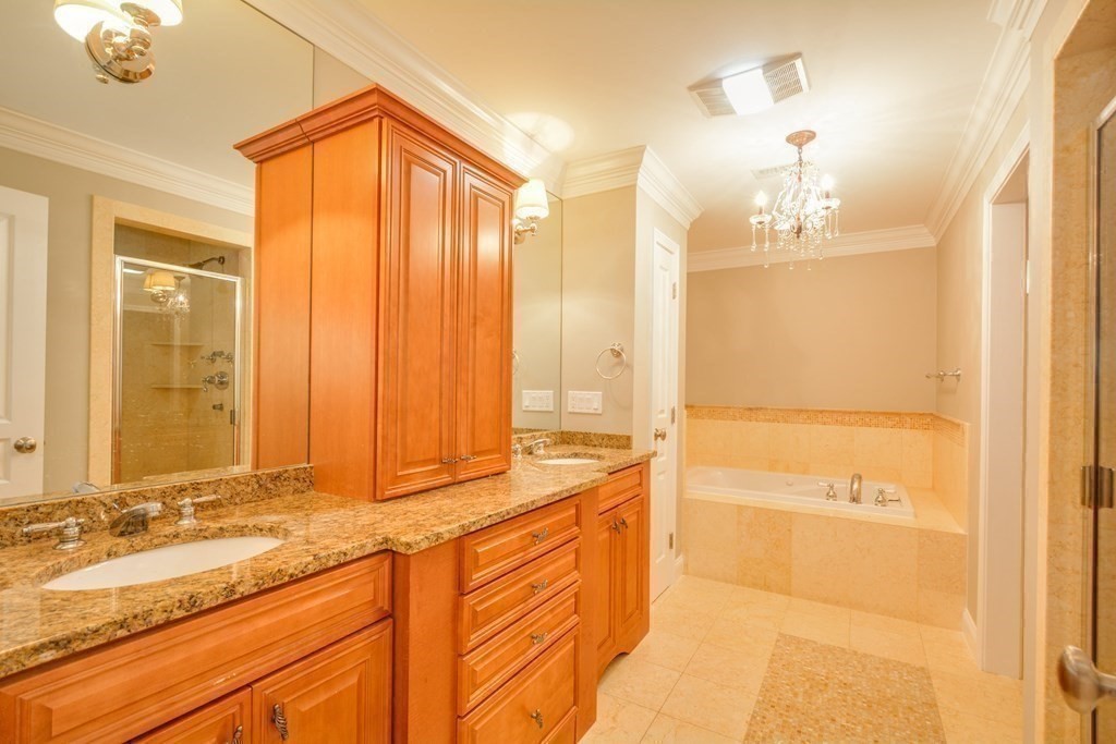 50 Tanglewood Road Newton, MA 02459 - Photo 18 of 42 a bathroom with a tub sink and mirror