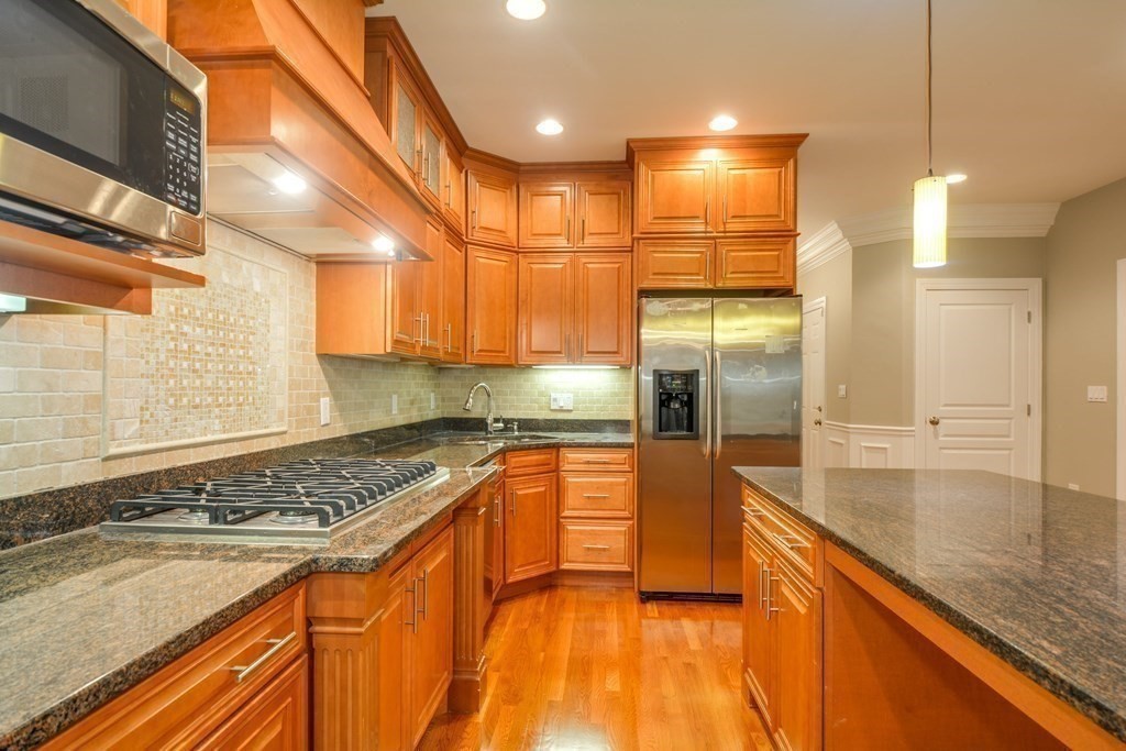50 Tanglewood Road Newton, MA 02459 - Photo 8 of 42 a kitchen with stainless steel appliances granite countertop a sink and a refrigerator
