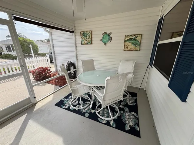 a view of a dining room with furniture and a floor to ceiling window