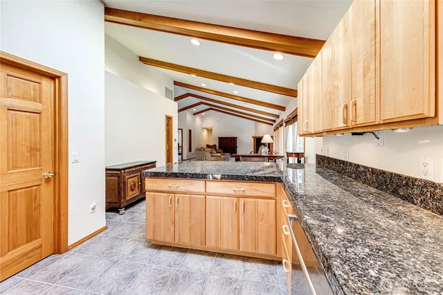 a kitchen with a stove and a wooden cabinets
