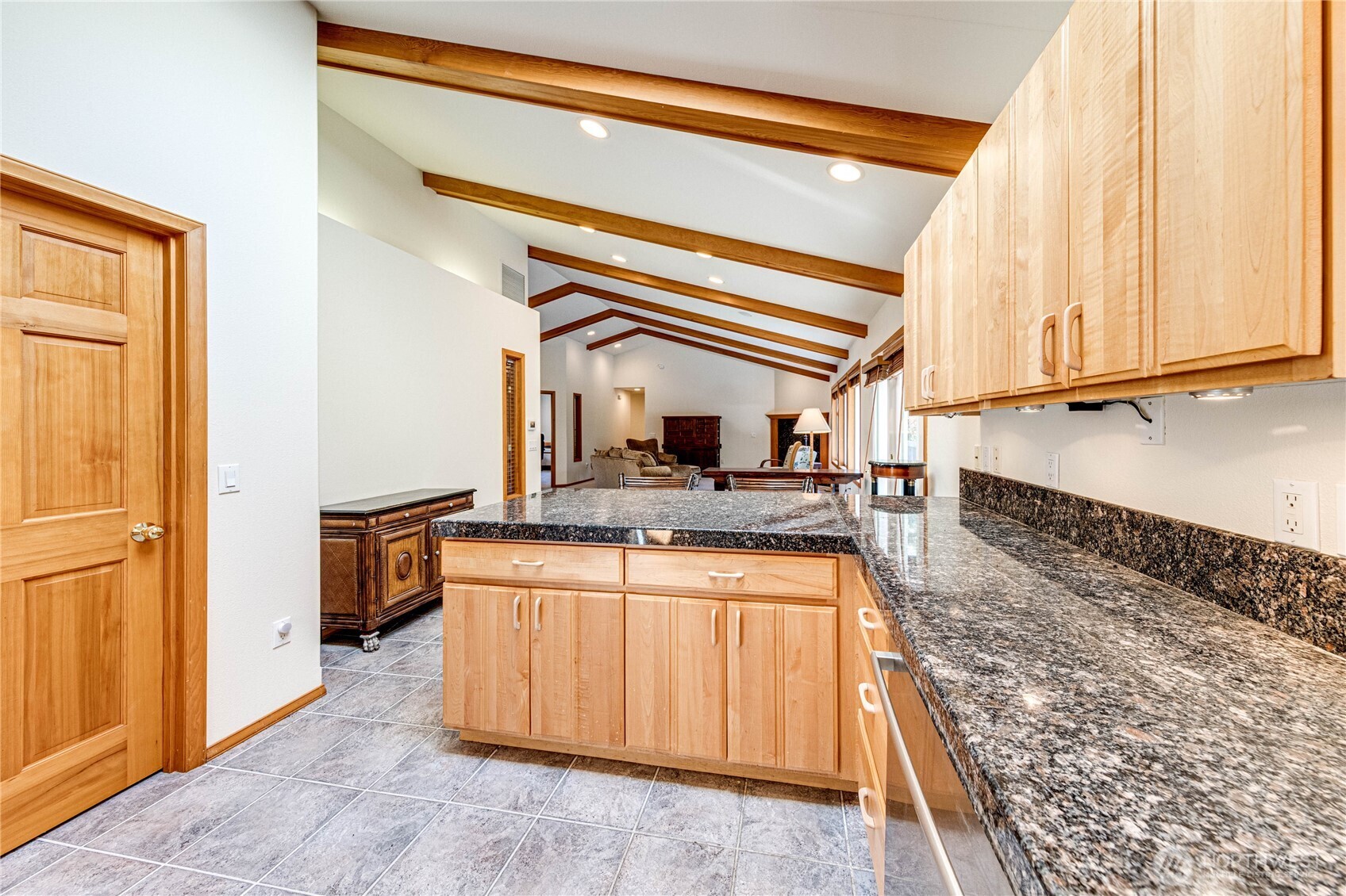 109 Vancouver Place Sequim, WA 98382 - Photo 13 of 40 a kitchen with a stove and a wooden cabinets