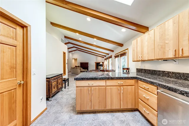 a kitchen with granite countertop a sink and cabinets