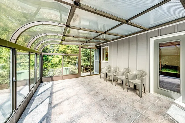 a view of an entryway with a floor to ceiling window