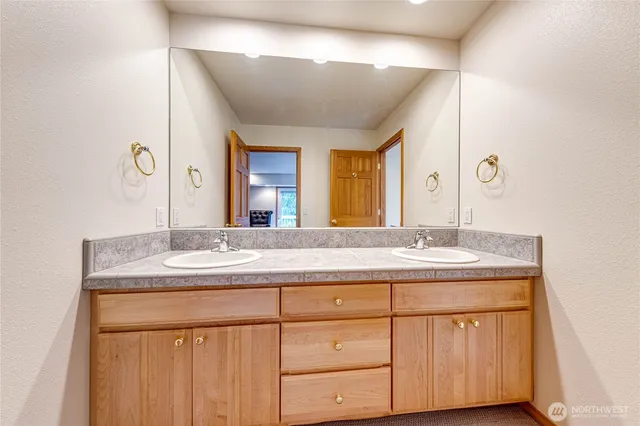 a bathroom with a granite countertop sink and a mirror