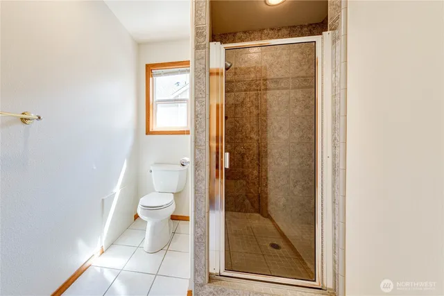 a bathroom with a glass shower door