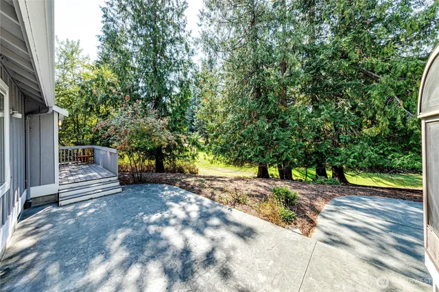 a view of a street with trees on both side of the house