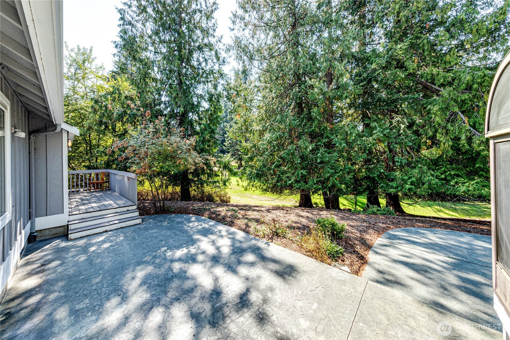 109 Vancouver Place Sequim, WA 98382 - Photo 28 of 40 a view of a street with trees on both side of the house