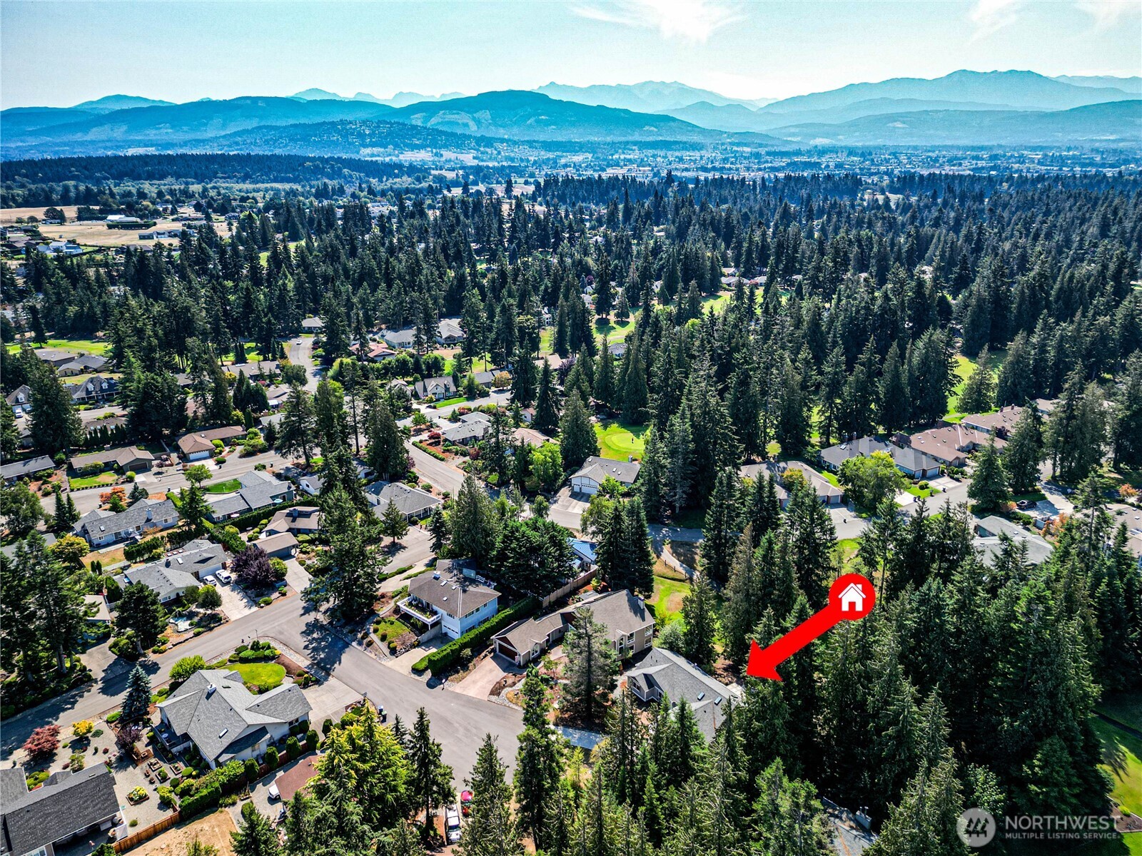 109 Vancouver Place Sequim, WA 98382 - Photo 40 of 40 a view of a house with a lush green forest