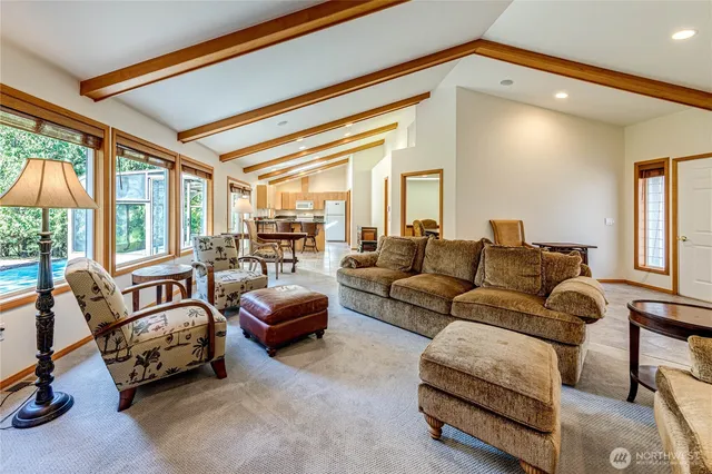 a living room with furniture and a floor to ceiling window