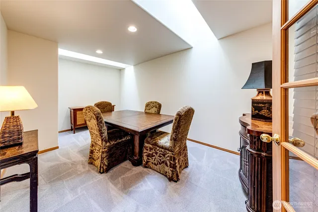 a view of a dining room with furniture and a chandelier