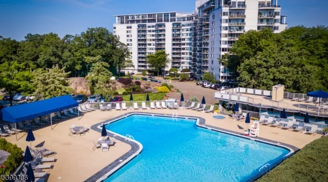 a swimming pool view with a outdoor seating
