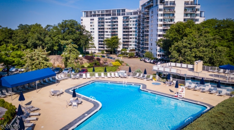 1 Claridge Drive, Unit 428 Verona, NJ 07044 - Photo 1 of 17 a swimming pool view with a outdoor seating