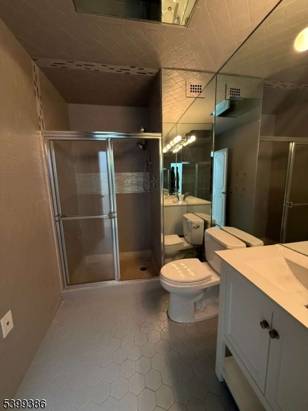 1 Claridge Drive, Unit 428 Verona, NJ 07044 - Photo 12 of 17 a bathroom with a sink a toilet and shower