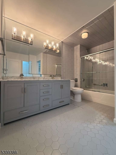 1 Claridge Drive, Unit 428 Verona, NJ 07044 - Photo 16 of 17 a bathroom with a granite countertop sink mirror and double