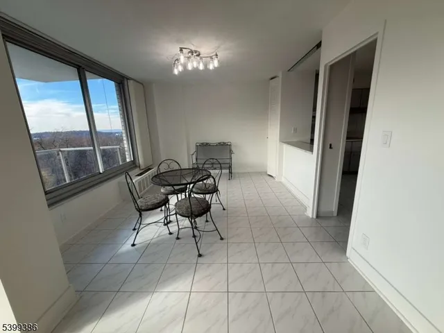 a view of an empty room and a window