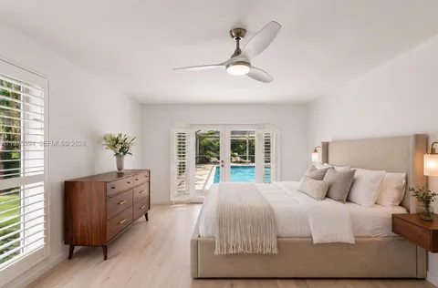 a bedroom with a large bed and a window