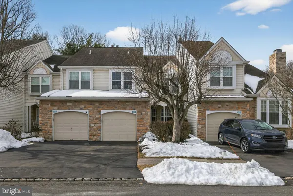 a front view of a house with a yard garage and outdoor seating