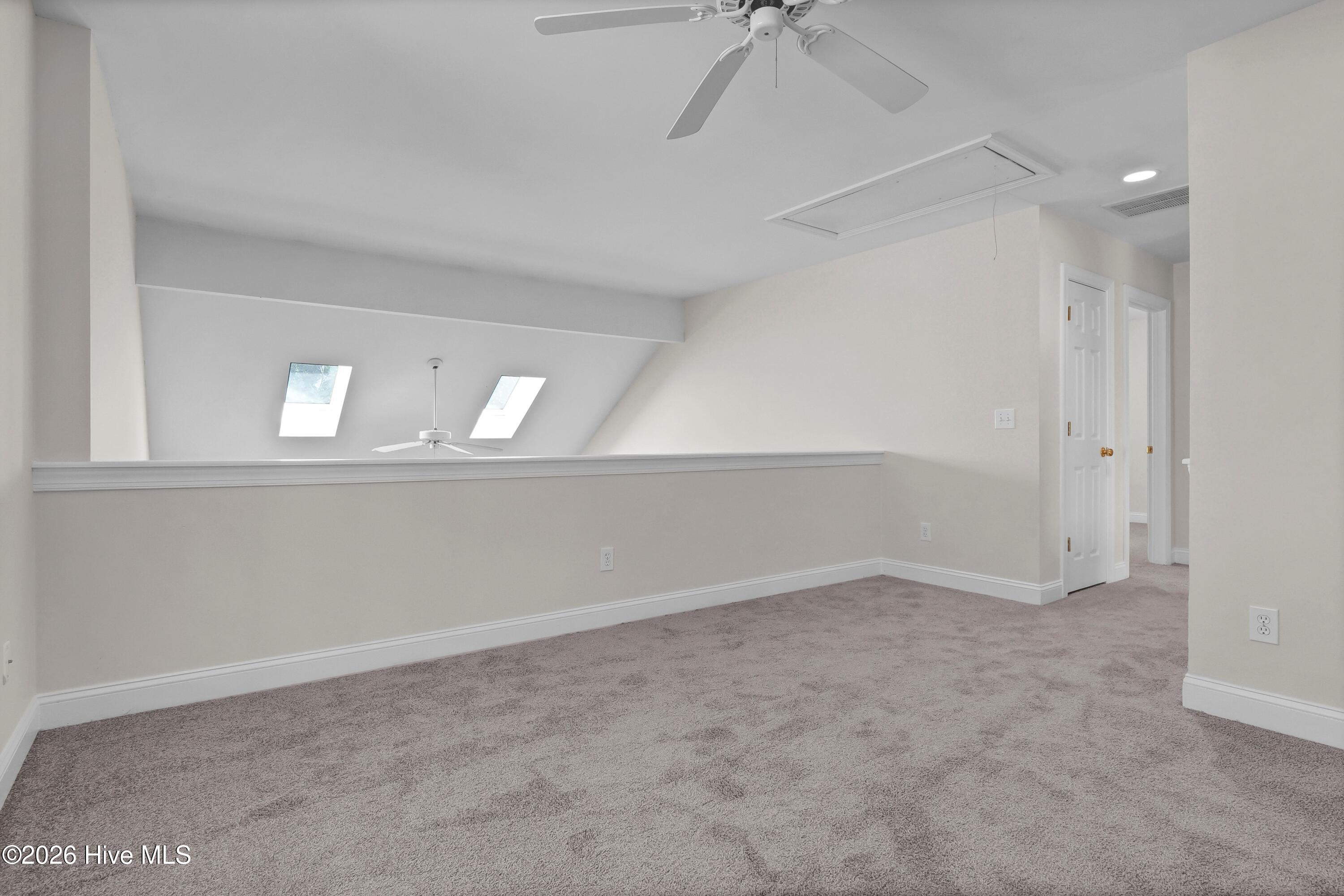 233 Racine Drive, Unit 59 Wilmington, NC 28403 - Photo 15 of 38 Open Loft overlooking living room. Skylights provide and window provide abunant light.