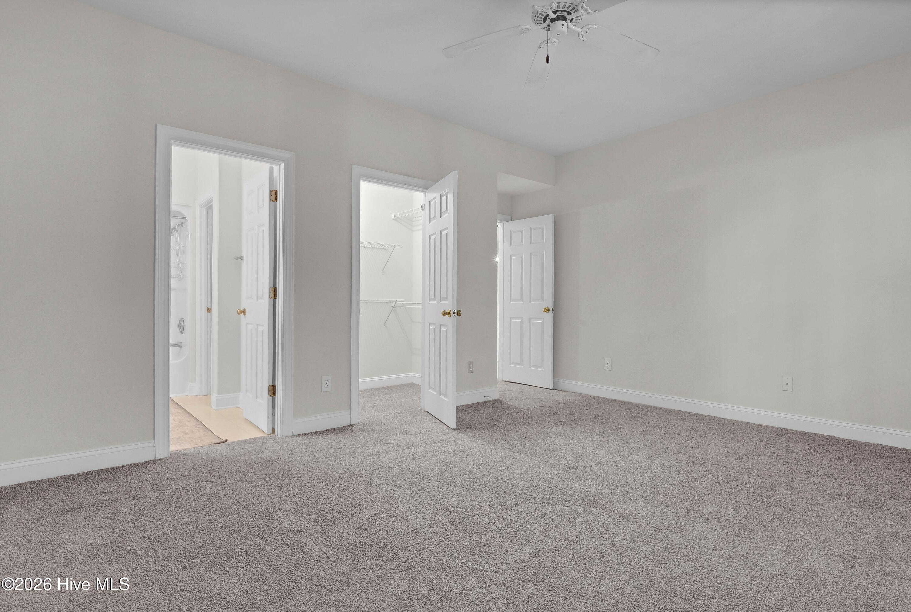 233 Racine Drive, Unit 59 Wilmington, NC 28403 - Photo 22 of 38 Primary bedroom on first floor with walk-in closet and ensuite bath