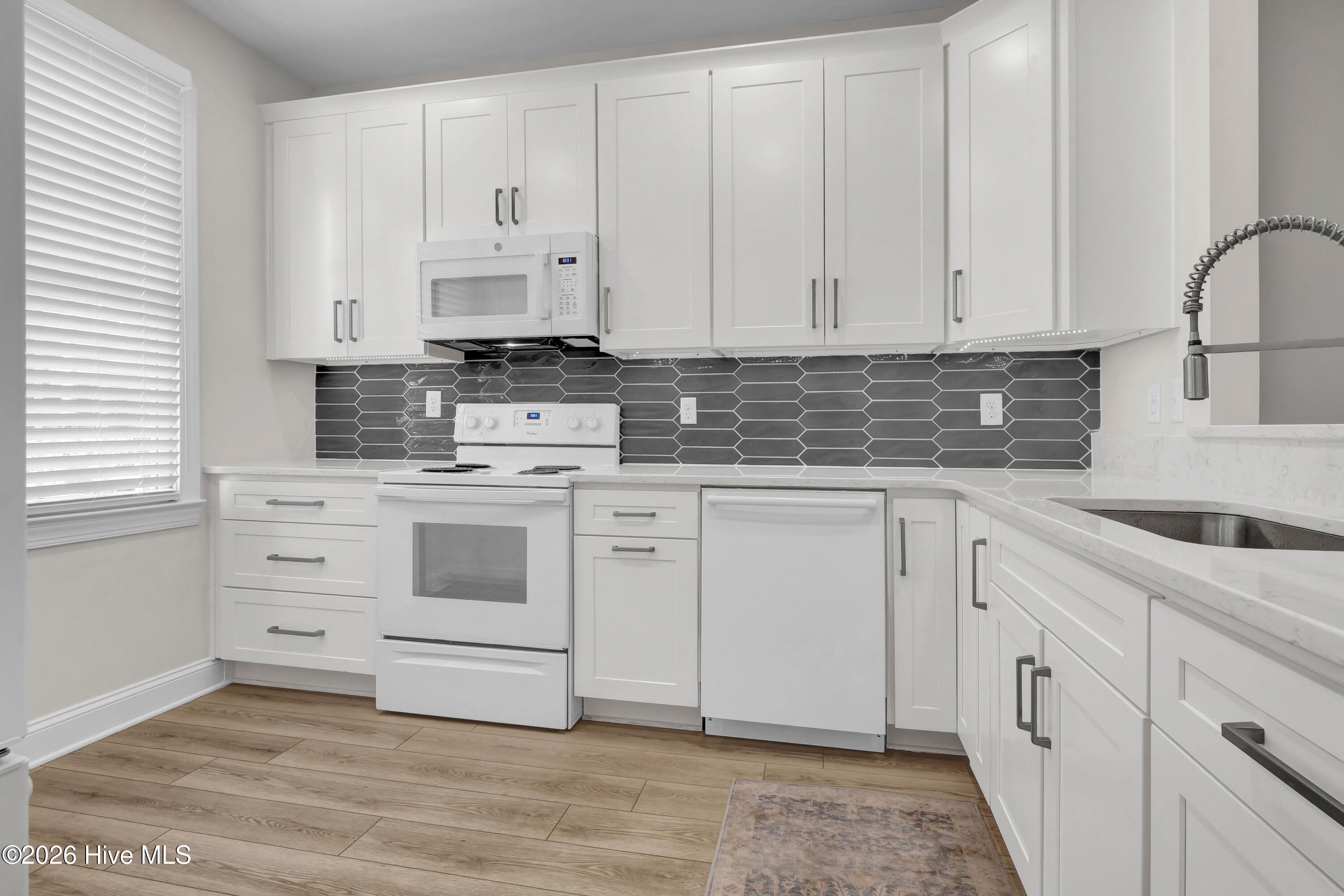 233 Racine Drive, Unit 59 Wilmington, NC 28403 - Photo 6 of 38 Updated cabinets, backsplash, sink, fixtures, flooring and appliances.