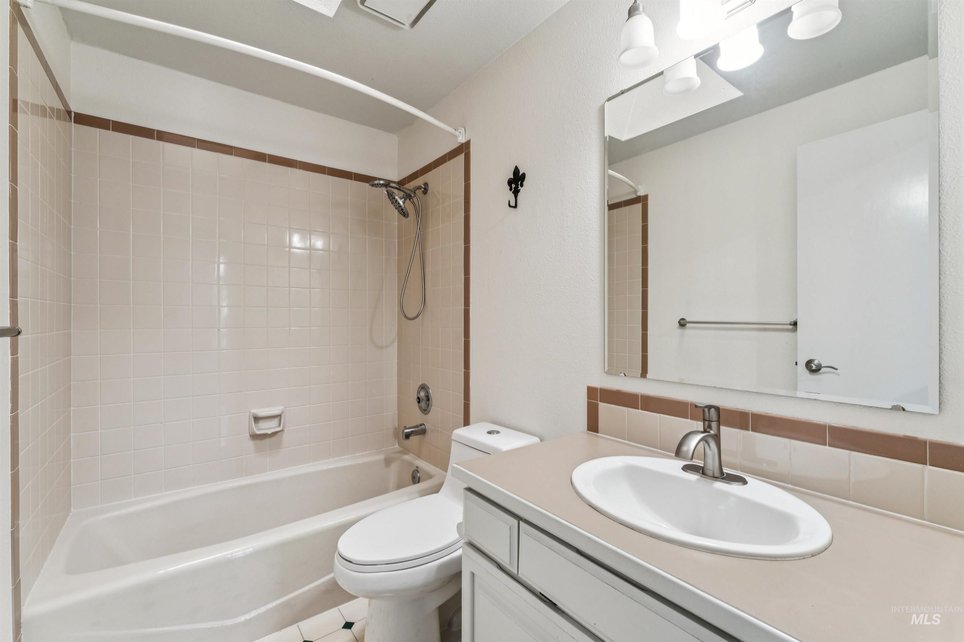 9831 West Ripley Street Boise, ID 83704 - Photo 33 of 47 Room featuring light gray walls, white tile flooring, and white baseboards