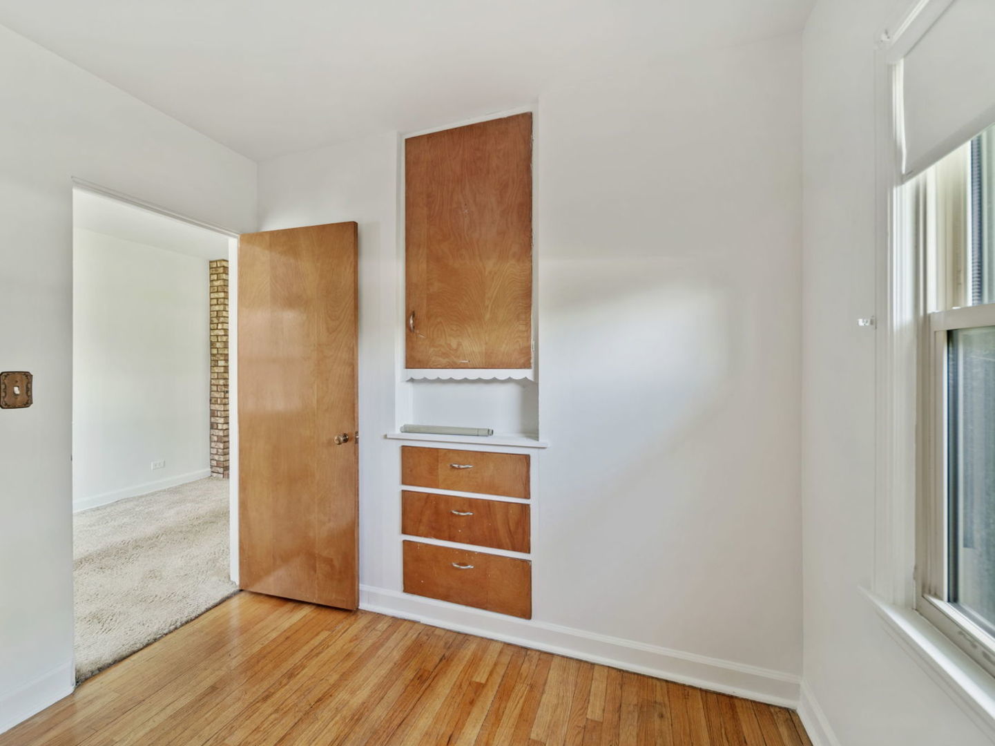 4N365 9th Avenue Addison, IL 60101 - Photo 2 of 24 a view of an empty room with wooden floor and a window