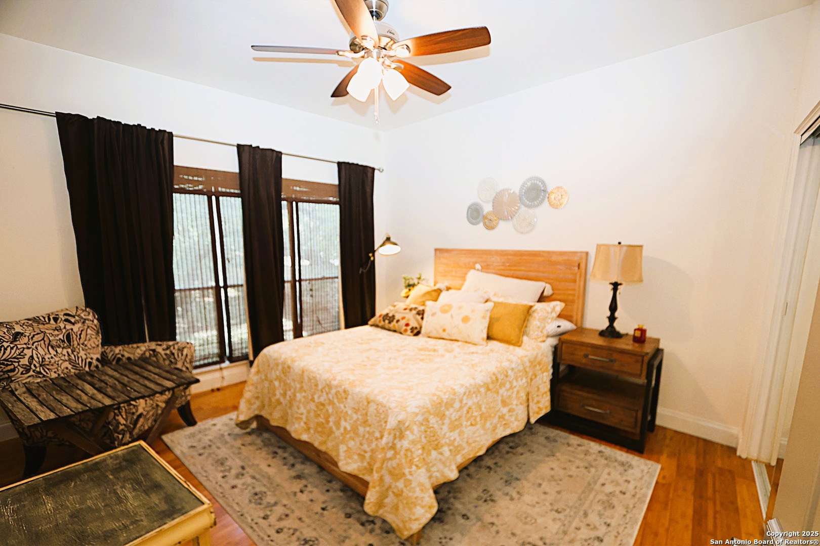 8642 Fredericksburg Road, Unit 402 San Antonio, TX 78240 - Photo 20 of 28 a bedroom with a bed and wooden floor