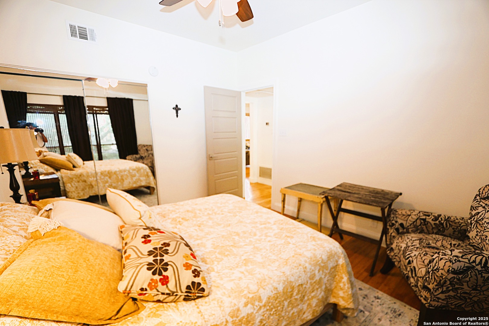 8642 Fredericksburg Road, Unit 402 San Antonio, TX 78240 - Photo 21 of 28 a bedroom with a bed and wooden floor