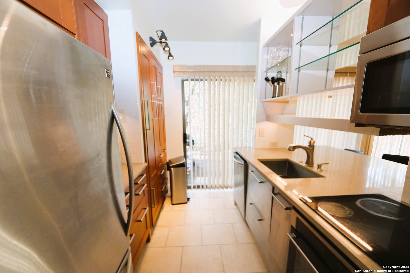 8642 Fredericksburg Road, Unit 402 San Antonio, TX 78240 - Photo 5 of 28 a kitchen with a sink a stove and a refrigerator