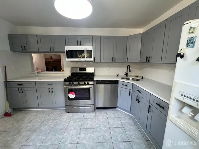 a kitchen with stainless steel appliances a stove sink and cabinets
