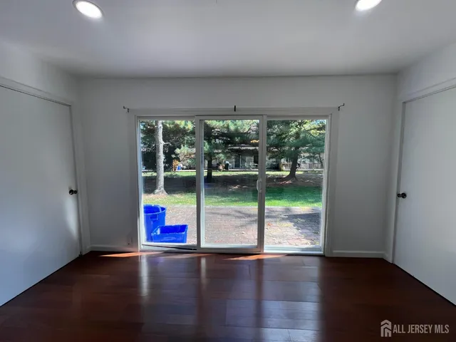 an empty room with floor to ceiling windows and pool table
